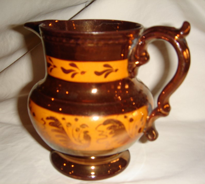 Brown and gold jug that belonged to Ellen Mercer.